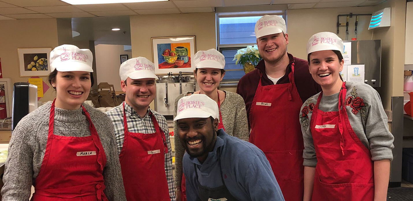 smiling group in aprons and hats