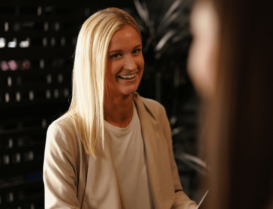 blonde woman in a suit smiling