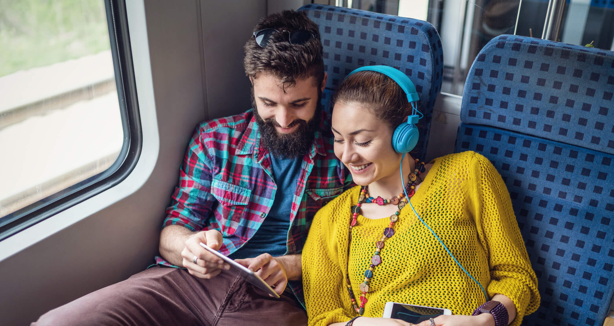 A couple listens to digital audio while travelling