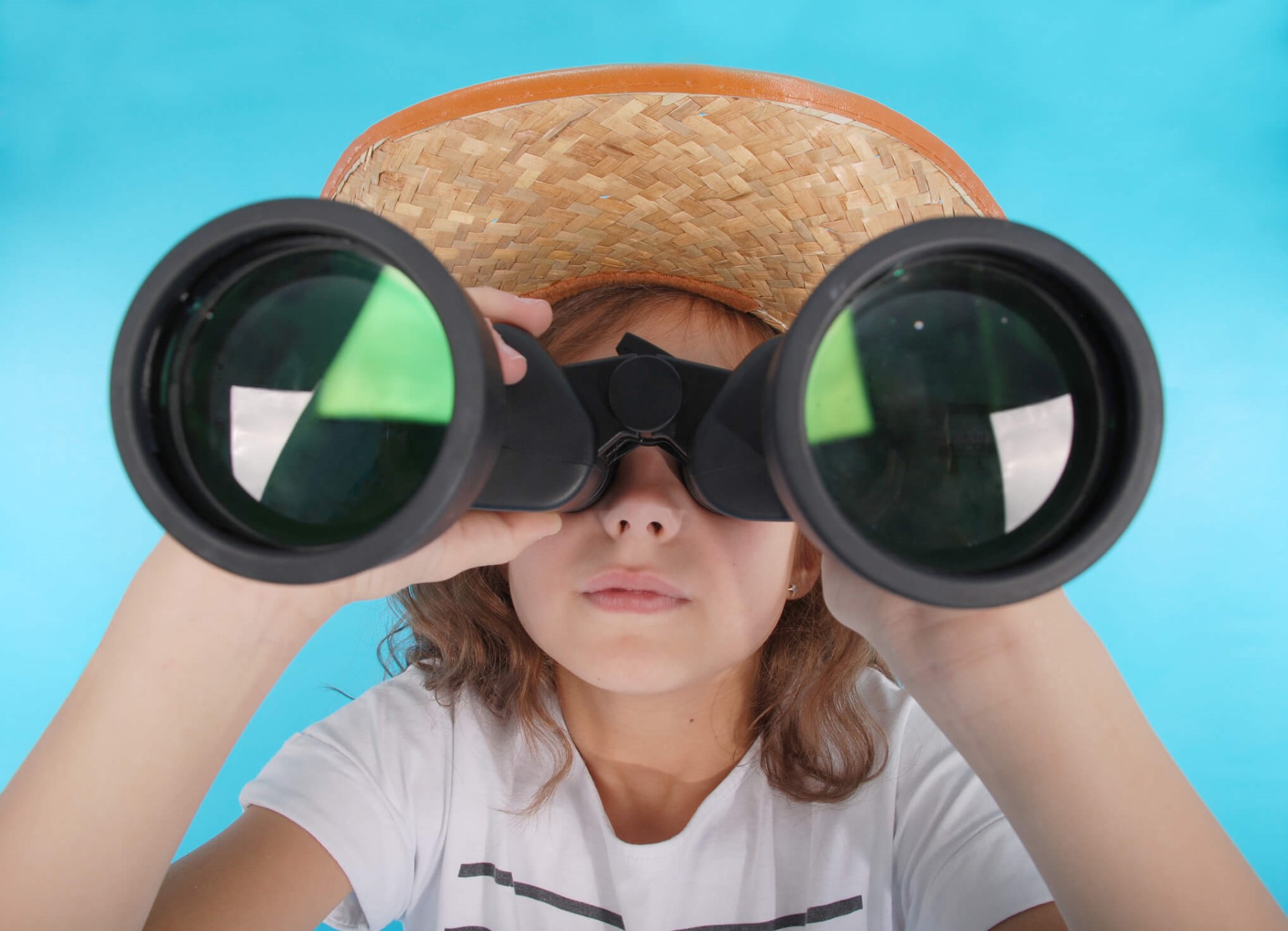 Young girl looking through binoculars