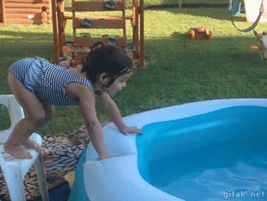 Little girl flipping awkwardly into an inflatable backyard swimming pool