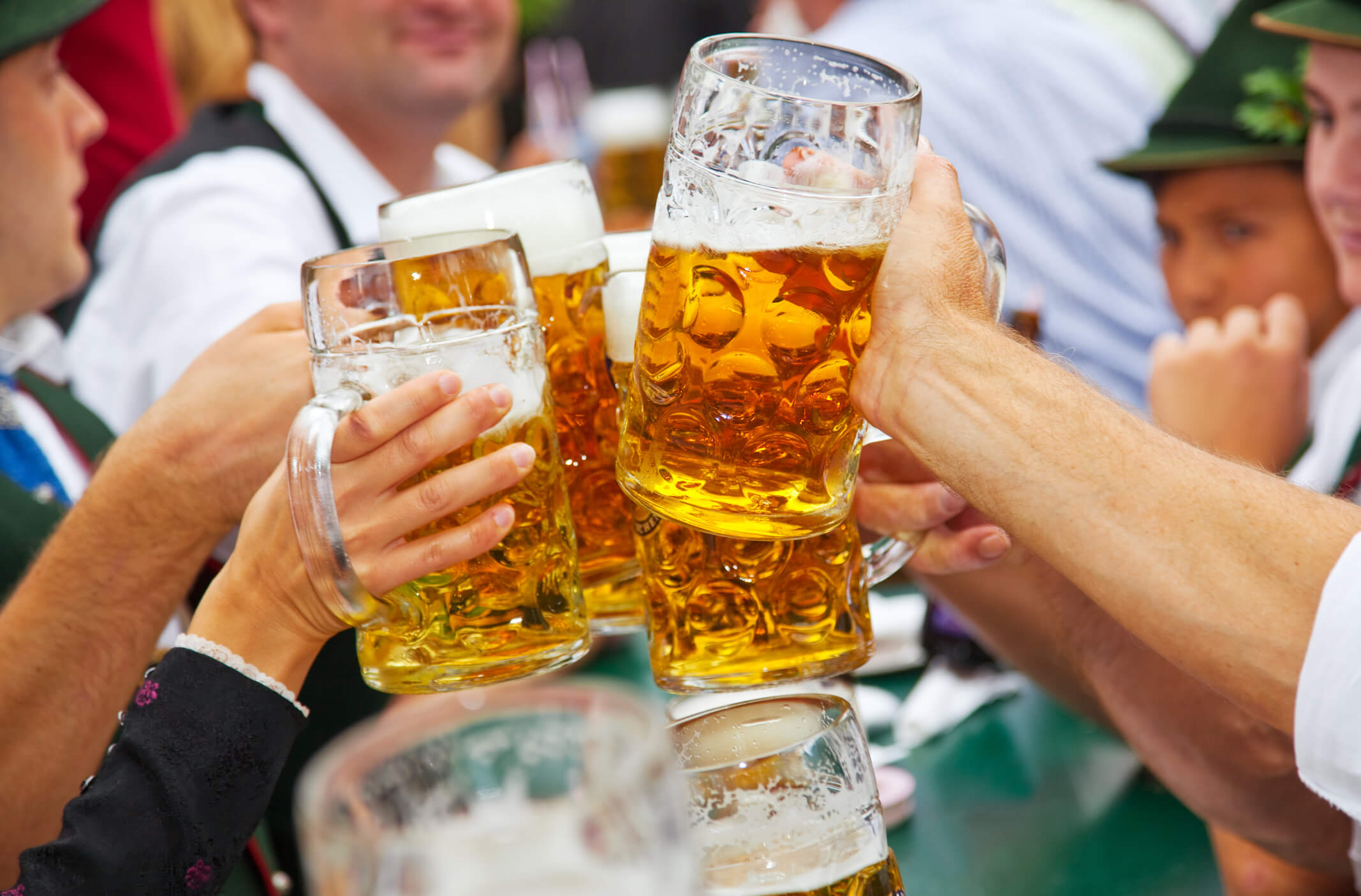 Beer steins clinking together in an Oktoberfest toast