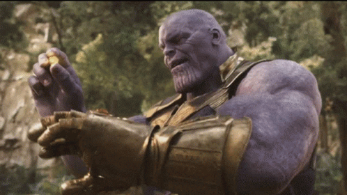 A GIF of Thanos adding the yellow stone to his infinity gauntlet and becoming even more powerful.