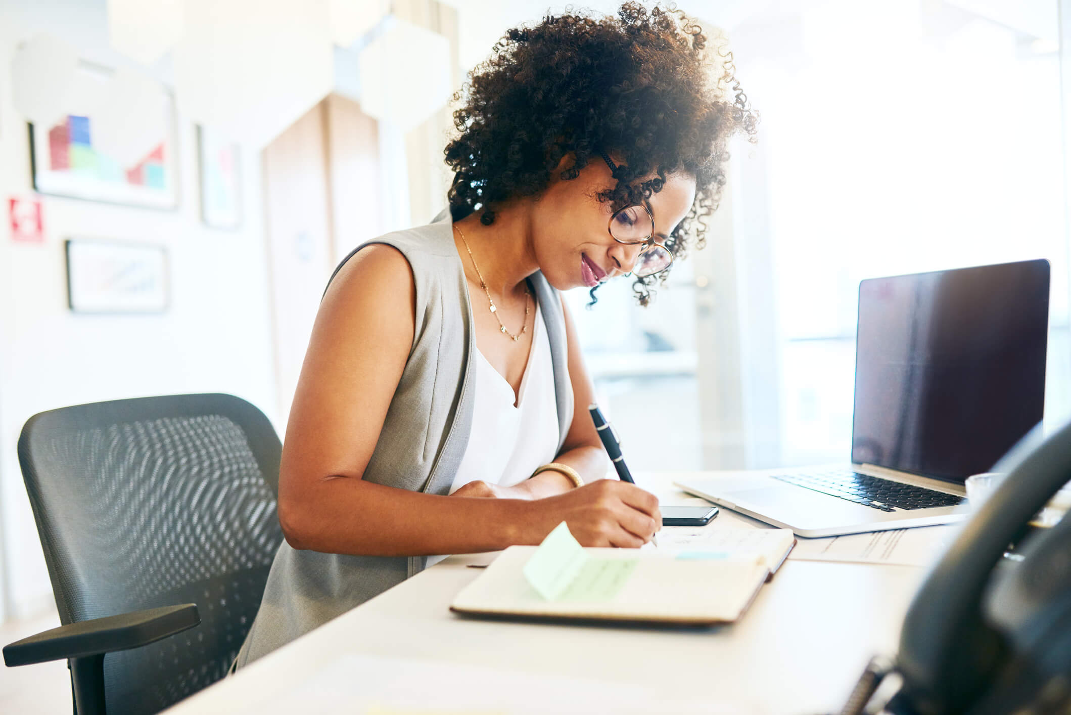 A businessperson, journaling at her desk.