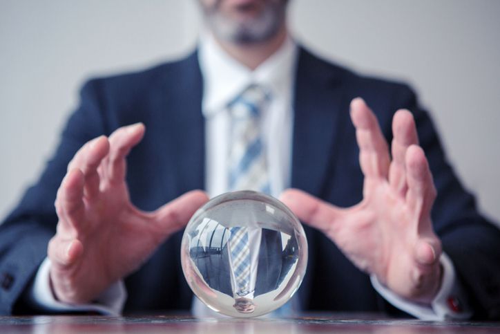 marketer looking into crystal ball on table