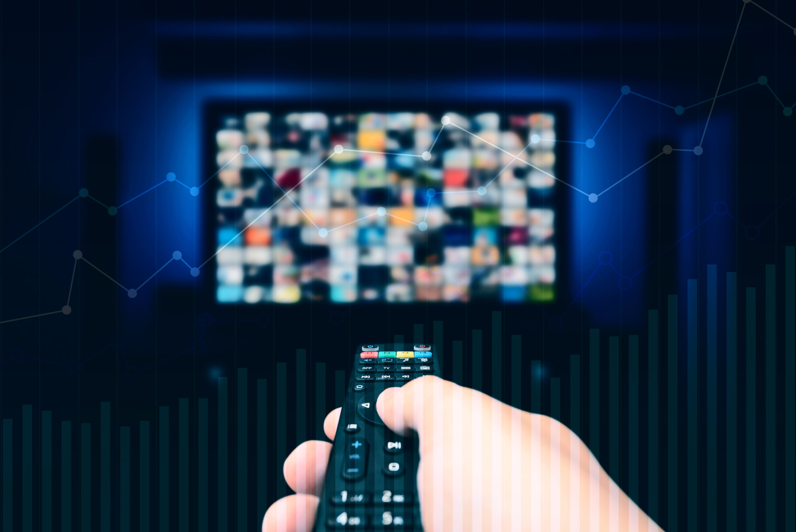 An image showing a viewer's hand holding a smart TV remote as they scroll through what to watch on their connected tv.