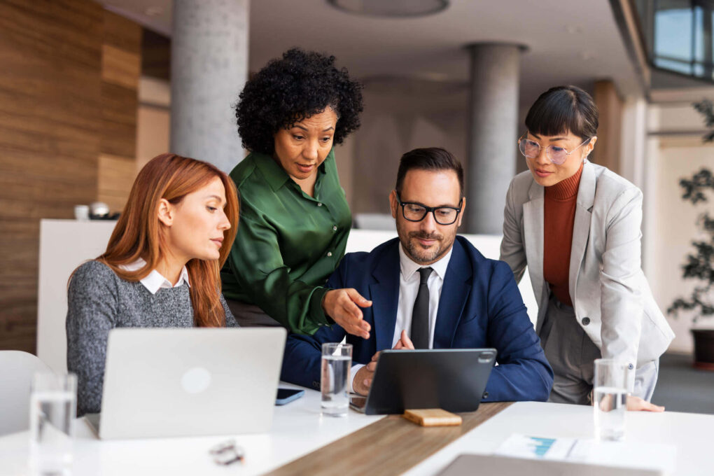 Marketers strategizing around their laptops