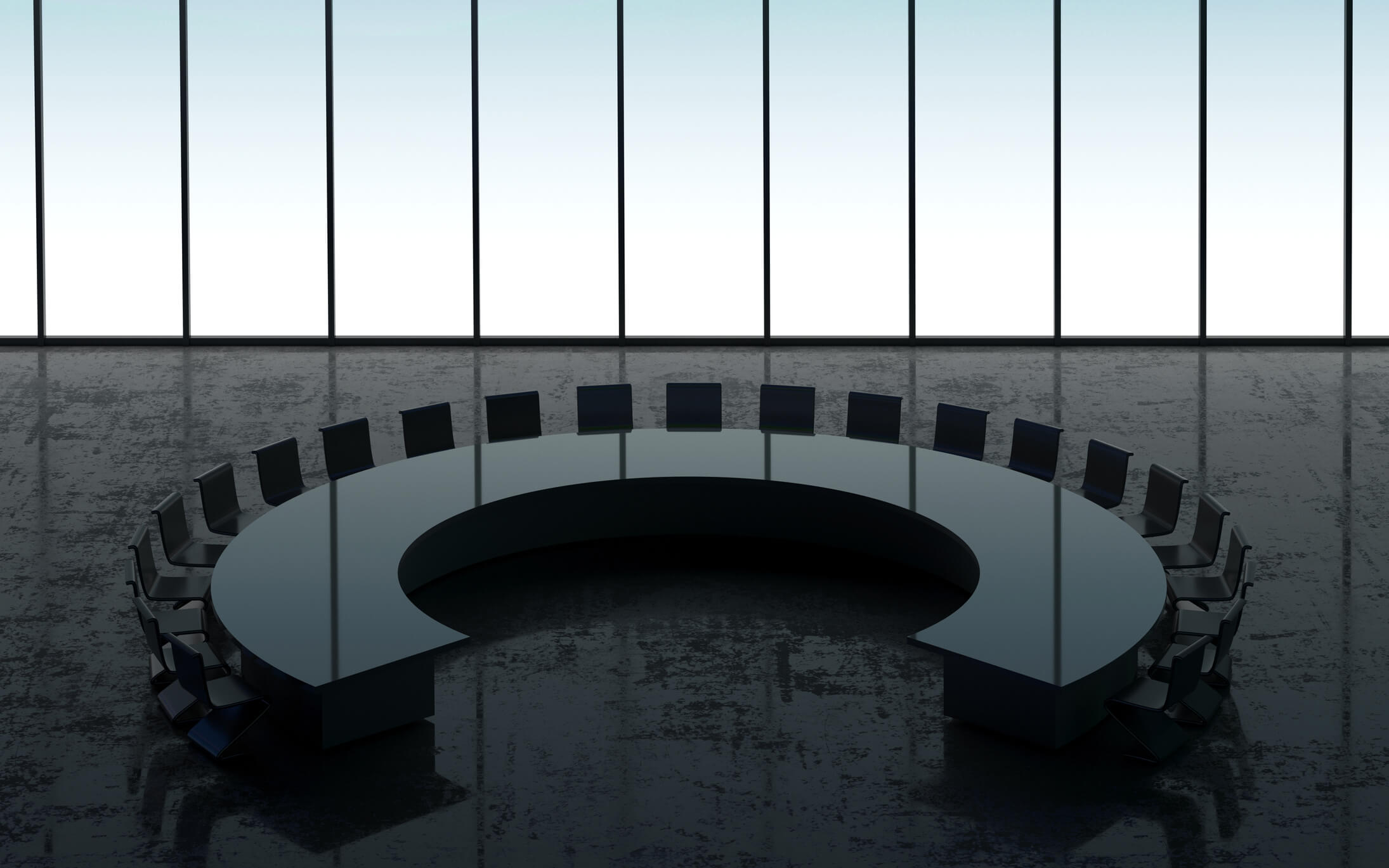 Picture of a conference room with a round table in the middle of it