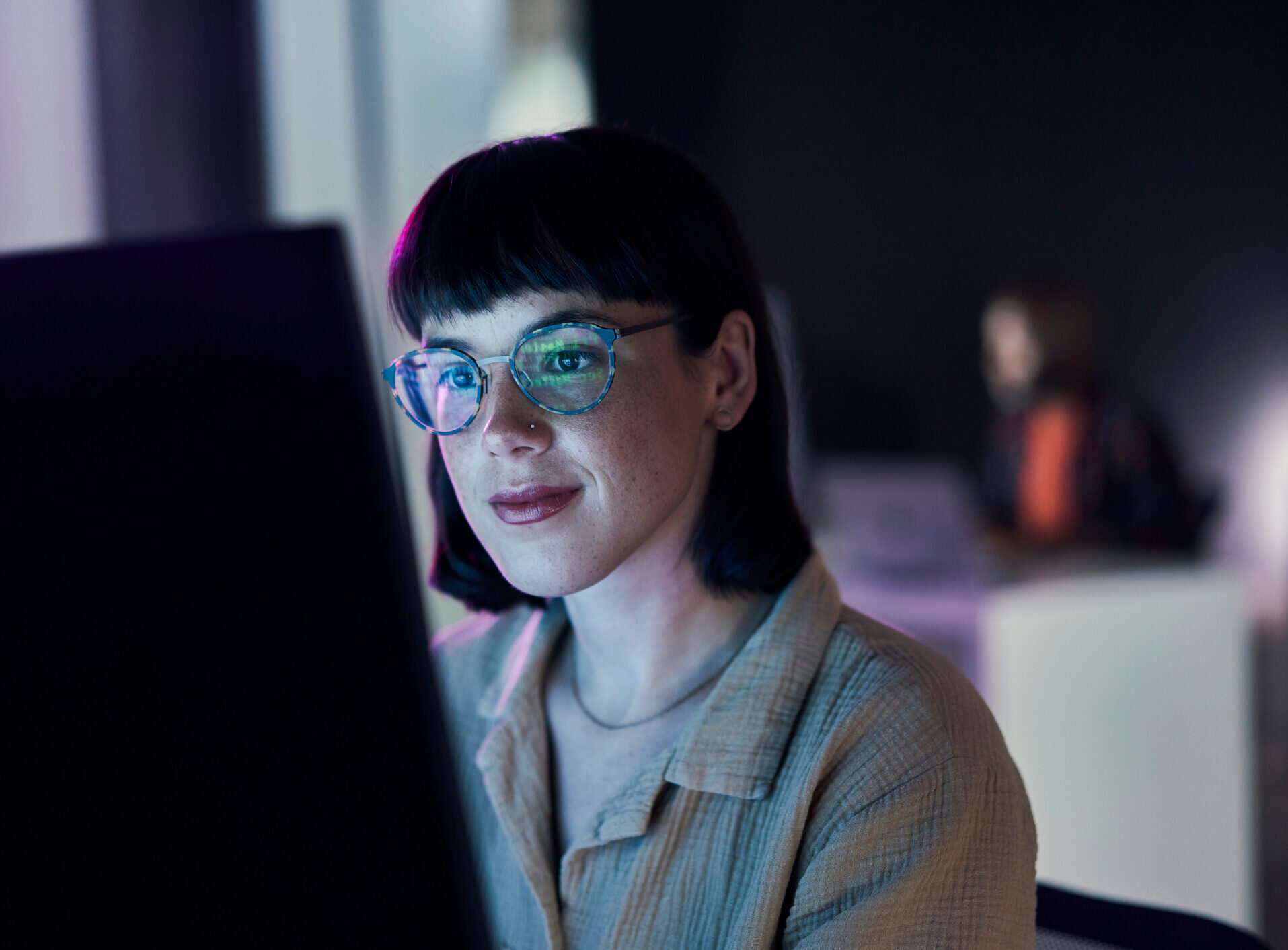 Woman working on her computer at a desk in an office