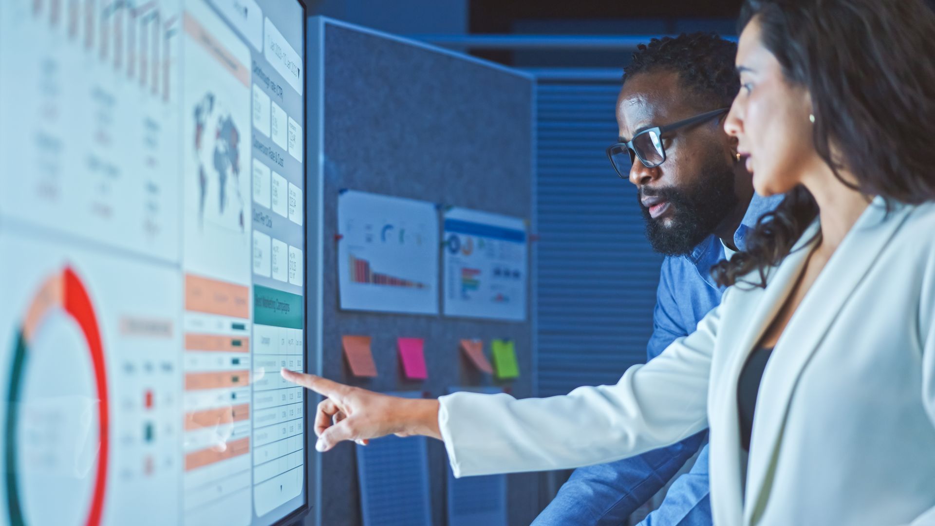 An image of two advertisers looking at data and considering how they can improve campaign effectiveness