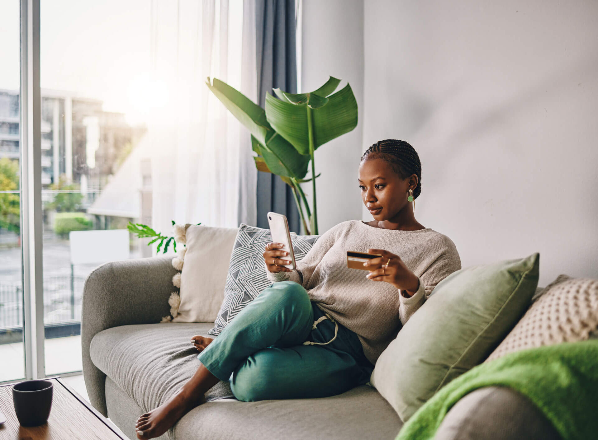 Woman at home online shopping on her phone
