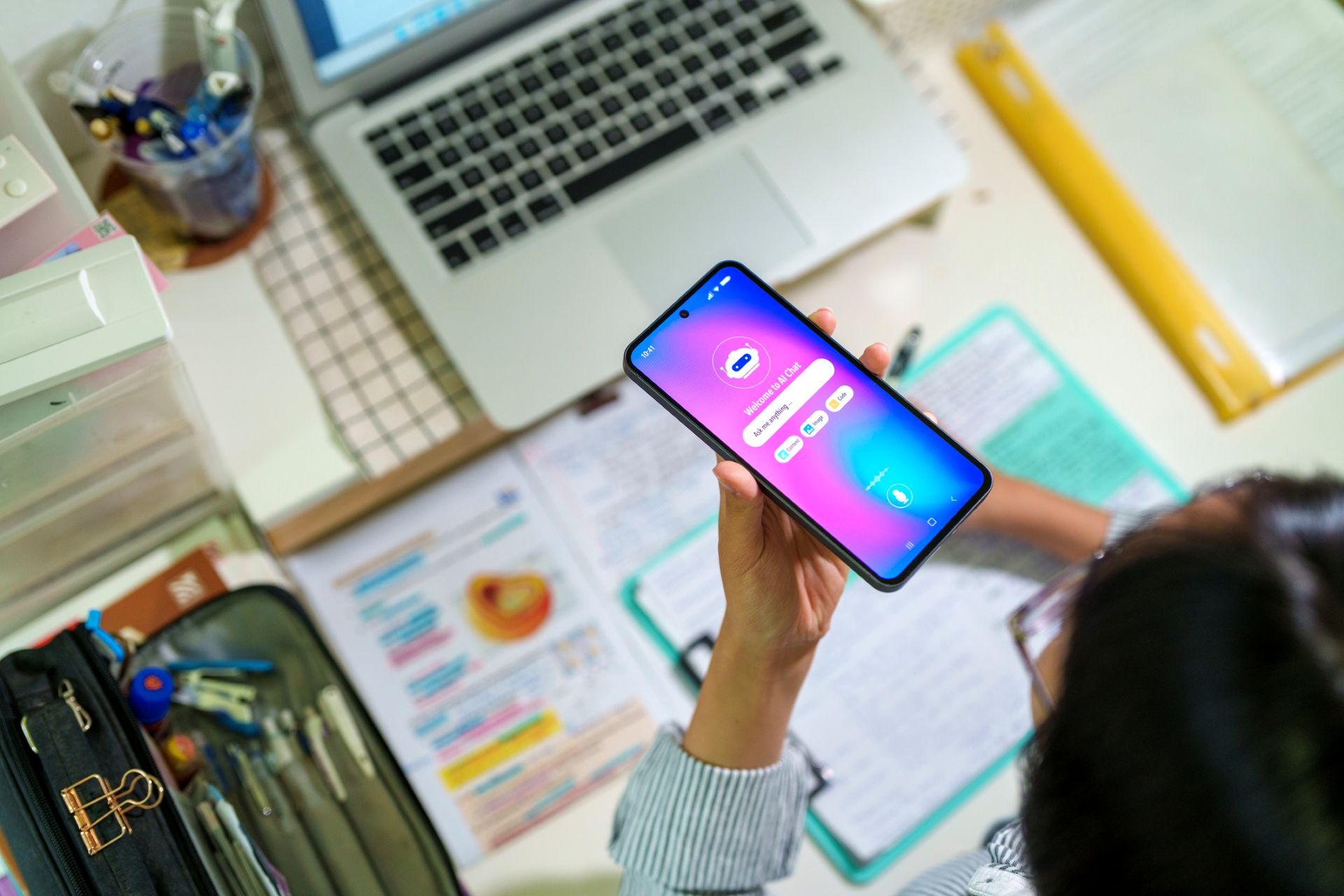 An image of a person using an AI chatbot while sitting at their laptop